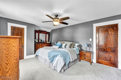 Carpeted bedroom with ceiling fan