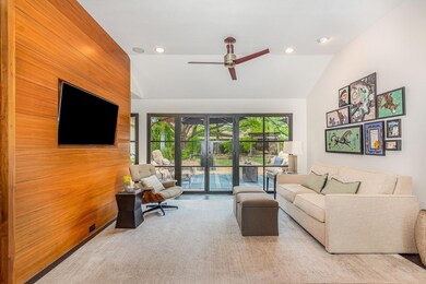 Living area with lofted ceiling, a ceiling fan, an