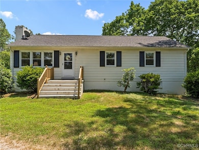 Ranch-style home with a chimney, a front yard, and