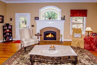 Fire-side Living Room has custom arched, deep wind