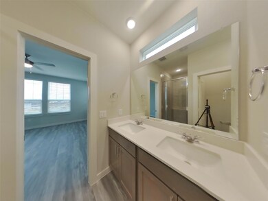 Bathroom featuring double vanity, wood finished f