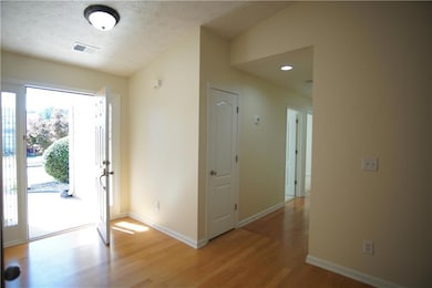 Entrance foyer featuring vaulted ceiling, a textur