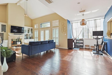 Living room with beam ceiling, a tiled fireplace, 