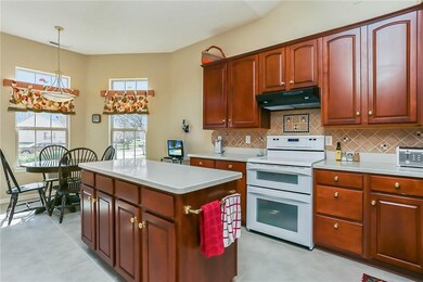 GORGEOUS KITCHEN WITH CORIAN COUNTER TOPS, CHERRY CABINETS (42 inch uppers) AND a 5 FOOT ISLAND.