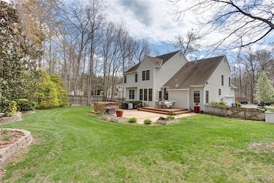 Back of property featuring fence, a deck, a jacuzz