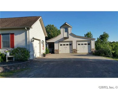 Exterior Front. PAVERS AND OVER GARAGE STORAGE WIT