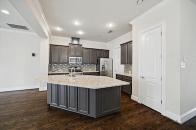This kitchen features dark cabinetry with a modern