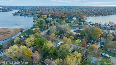 Aerial view of property and surrounding area featuring a nearby body of water