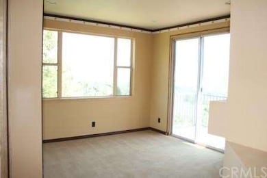 Bright and cheery living room with fireplace and b