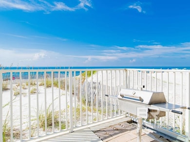 Balcony with grilling area, a water view, and a view of the beach