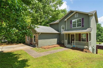 Traditional home featuring covered porch, roof wit
