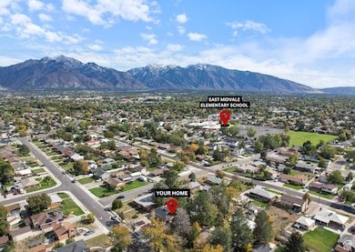 Aerial overview of property's location with a mountain backdrop and nearby suburban area