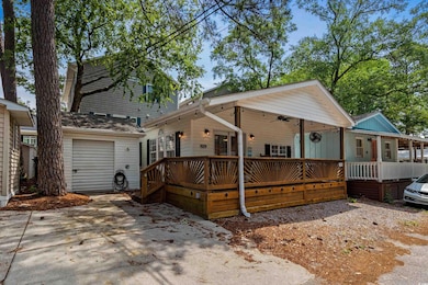 View of front of property with a deck, concrete dr