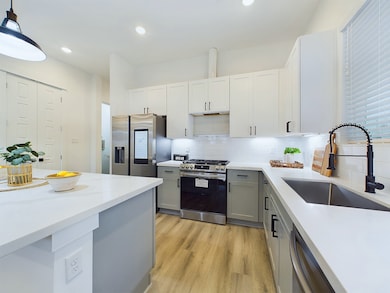 The kitchen offers quartz countertops, stainless s