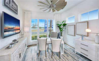 Dining area featuring ceiling fan and light wood-style flooring