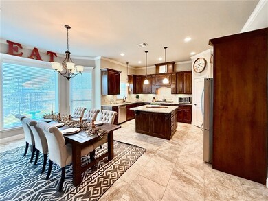 Dining space featuring crown molding, a chandelier