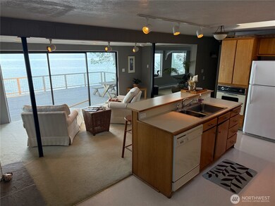 Kitchen Island with a breakfast bar overlooking the living room and the water view.