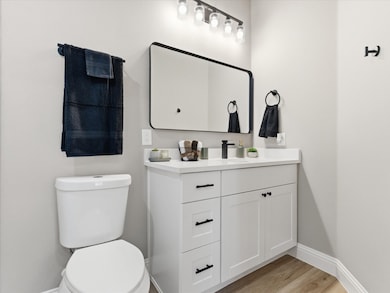 Bathroom with light wood finished floors and vanity