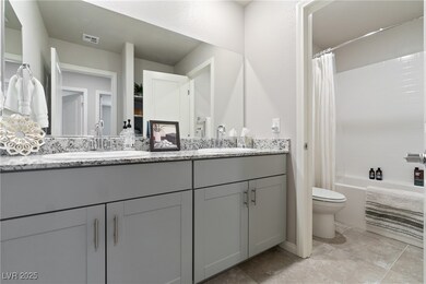Bathroom with double vanity and shower / tub combo