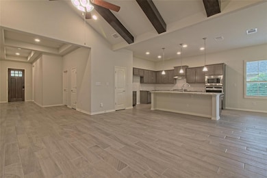Kitchen with open floor plan, appliances with sta