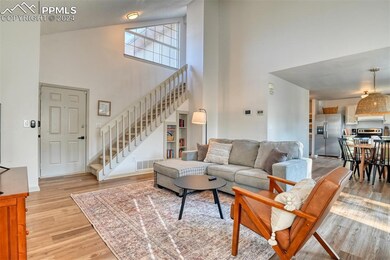 Living room with high vaulted ceiling and light ha
