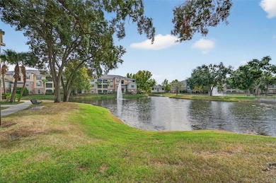 The beautifully landscaped grounds of Courtney Palms create a tranquil, resort-style atmosphere surrounded by nature and water views. Meandering sidewalks and walking paths wind around sparkling ponds accented by fountains and mature shade trees, offering a peaceful place to stroll, relax, or enjoy morning coffee by the water. Well-maintained lawns and tropical landscaping add to the community’s charm, while scenic seating areas provide the perfect spots to unwind and take in the view. The serene outdoor environment enhances the lifestyle of this gated community, combining privacy, beauty, and Florida living at its best.