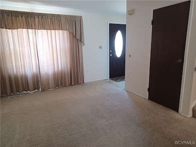 Foyer featuring carpet and visible vents