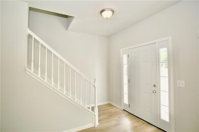 Entrance foyer with stairs and  wood-type flooring