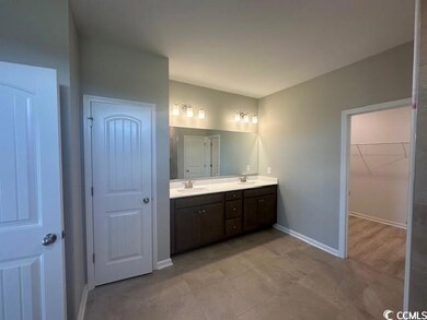 Bathroom with tile patterned flooring and dual bow