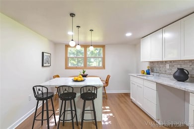 Kitchen space with new cabinets, counters & backsp