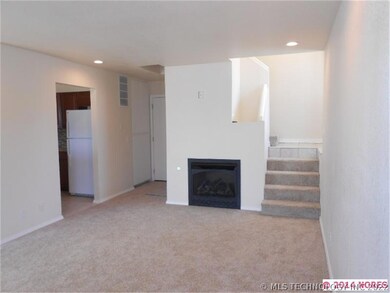 living area view of entry and fireplace. Owner ins