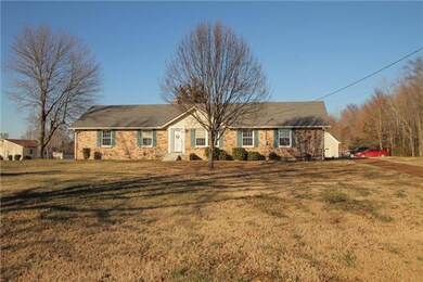All Brick, 1 Level Home with Level Front Yard is located on 21.89 Acres (2 Parcels) with Pond.