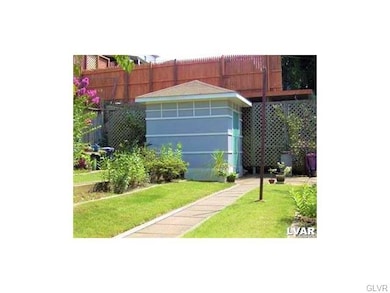 Yard in late summer showing garden shed and patio 