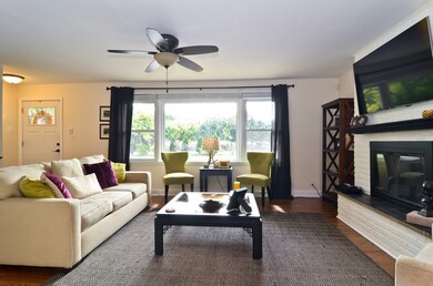 Cozy, sun filled living room with hardwood floors,