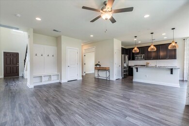 Living area featuring dark wood-style flooring, a