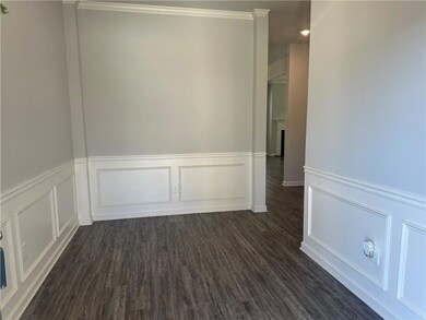 Spare room with dark wood-type flooring and crown 