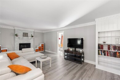 Hardwood floored living room with a large fireplac
