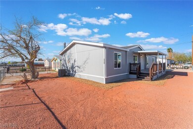 View of side of home featuring a porch, fence, and