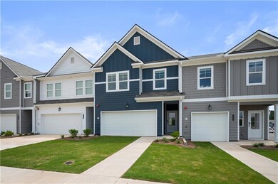 Craftsman inspired home featuring board and batten siding, a front yard, driveway, and a garage
