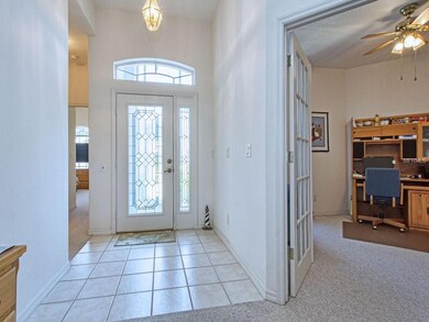 Foyer plus Den/Study on right (French doors)