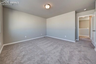 Empty room featuring light carpet