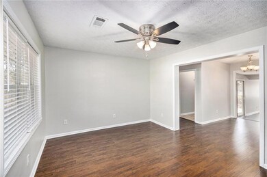 Empty room with dark wood finished floors, ceiling