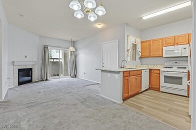 Kitchen featuring white appliances, a chandelier,