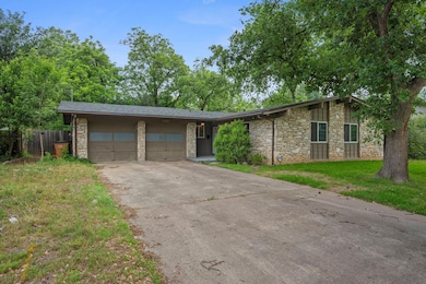 Mid-century modern home featuring stone siding, a