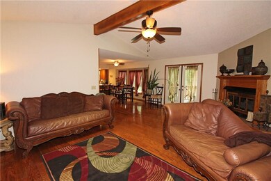 Living room with doors to porch overlooking the pool.