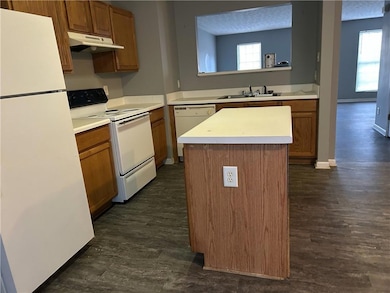 Kitchen with a kitchen island, white appliances, d
