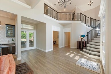 The elegant entry staircase is open to the living areas.