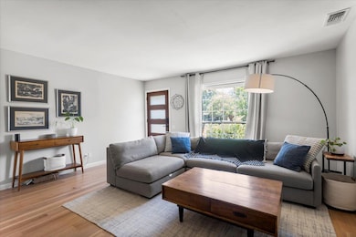 Living area with light wood-type flooring and bas