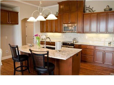 The kitchen boasts a whole wall of cherry cabinetr