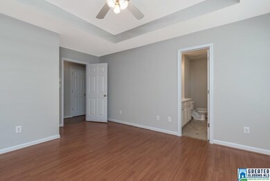 The master bedroom has hardwood laminate floors, a